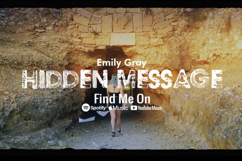 A woman walks into a cave behind text that reads "Emily Gray - Hidden Message"