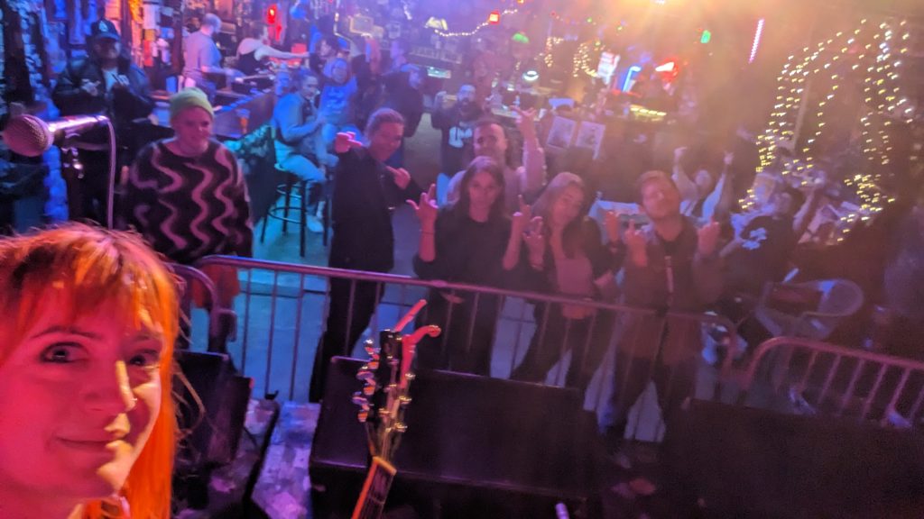 Ellie takes a selfie from the stage in Birmingham where the audience is flipping off the band.