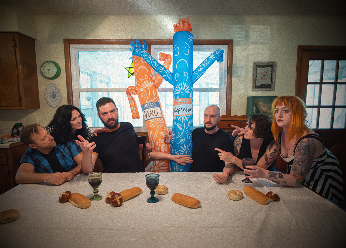 The members of The Cancellations gather around a table in the style of the Last Supper. The table is adorned with bread loaves and wine goblets, some in suggestive shapes. At the center of the portrait stand Depression and Dance, The Cancellations' wacky waving flailing arm flailing tube friends.